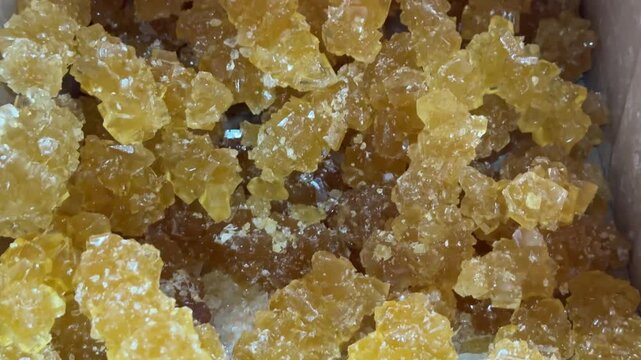 crystal rock candy, Iranian Nabat lollipops on sale at the market, close-up.  Persian crystallized sugar. closeup view of traditional Persian crystallized sugar. brown sugar, brown crystal