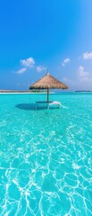 A serene tropical scene featuring a thatched umbrella and lounge chair standing in crystal-clear, shallow turquoise water under a bright blue sky with scattered clouds.