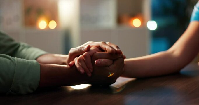 Couple, love and holding hands on table for care, support and commitment with bokeh on date. Man, woman and comfort with trust for bonding together, respect or connection for marriage in restaurant