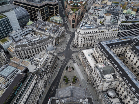 Aerial view of grand buildings flanking intricate streets, a tapestry of architectural styles basking in subtle daylight, London, England, United Kingdom.
