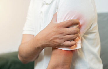 Close-up shot of man experiencing arm pain with highlighted inflammation, symbolizing muscle