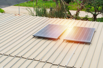 Mini solar panels installation on a roof of a storage building during sunny day in a rural resort.