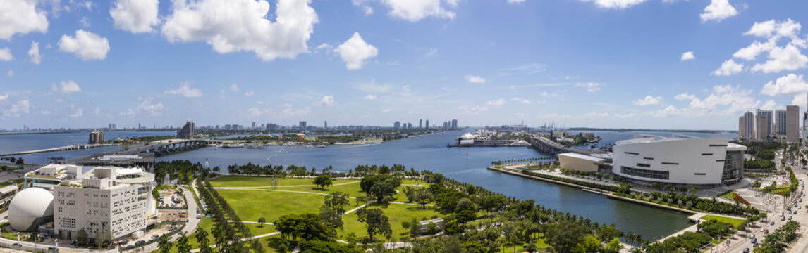 Aerial view of the Perez Art Museum Miami and the FTX Arena shimmer under a sunny sky, framed by the MacArthur Causeway and Biscayne Bay, Miami, Florida, United States.