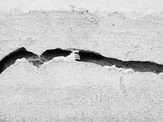 Crack wall texture background broken earthquake effect, whtie grey building cement damage pattern plaster grunge black line paint surface abstract, construction rough street concrete backdrop.