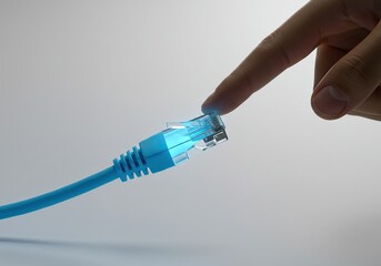 Human Finger Touching Glowing Blue Ethernet Cable - Concept of Connectivity, Internet Access, and Digital Interaction.