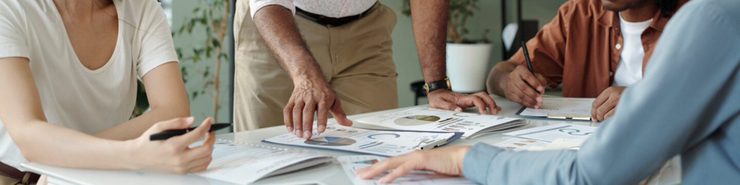 Team discussing paperwork in an office setting