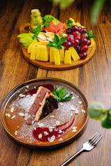 Delicious dessert plate with fresh fruit display in a cozy restaurant setting