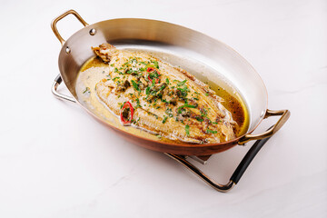 Deliciously cooked whole fish garnished with fresh herbs and spices