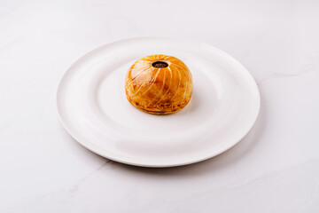 Delicious spherical dessert presented on a white plate for elegant dining