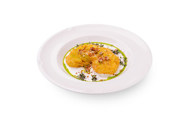 Crispy golden fritters served on a plate with fresh herbs and sauce