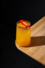 Refreshing cocktail with a spicy twist served on a wooden table