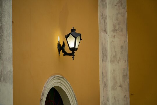 Vintage lamp on yellow wall