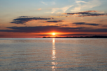 red and orange sunset over Lake Constance and the island of Lindau in Germany with beautiful clouds...