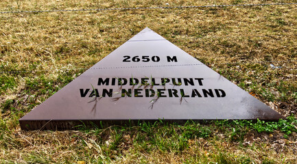Metal triangular sign indicating the geographic center of netherlands with altitude of 2650 meters...
