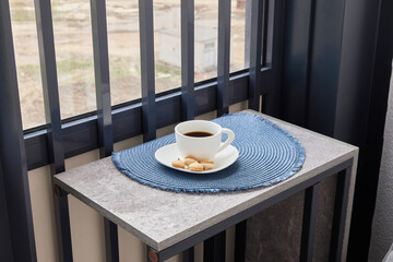 A cozy coffee setting on a modern balcony table, perfect for a delightful breakfast or brunch