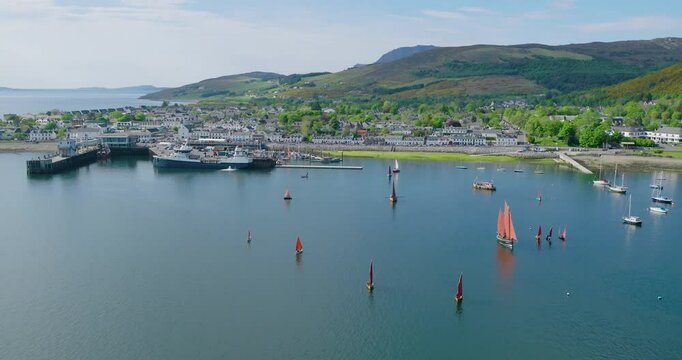Lugger boats sail peacefully down Loch Broom during Ullapools 2024 maritime Lugger Fest
