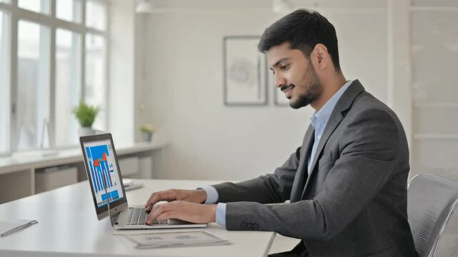 Businessman uses capable laptop computer to analyse business data analytic for marketing strategy and customer relationship management