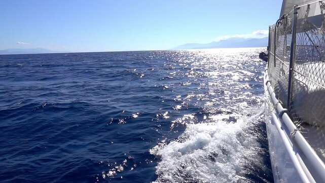 Sunny path on water and sea foam from under the yacht. Slow motion