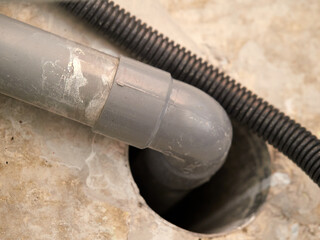 Trachea tubes next to a water pipe in the false ceiling of a home.