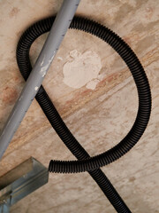 Trachea tubes next to a water pipe in the false ceiling of a home.