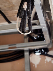 Trachea tubes next to a water pipe in the false ceiling of a home.
