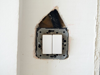 Hole made in plasterboard wall to change the location of a switch
