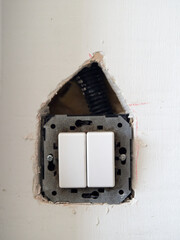 Hole made in plasterboard wall to change the location of a switch