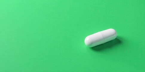 White triangular pill on green background; minimalist medical imagery, organic, image, geometry