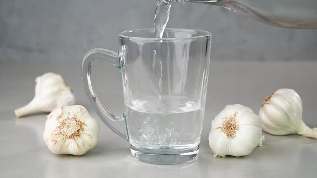 Serving garlic water in a glass cup.