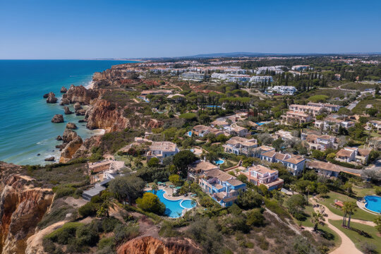 Aerial view of luxury coastal villas overlooking the ocean in portugal on a sunny day