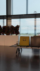 Viena, Austria - May 05, 2025: Modern airport lounge area with seating, plants, and large windows...