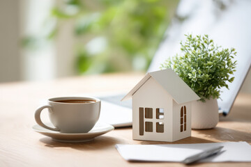 Blank property listing flyer on desk with plant and coffee cup for real estate branding