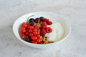 Healthy Breakfast Bowl with raspberry gooseberry and red currant Berries and Yogurt