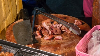 Grilled Pork on Wooden Cutting Board at Night Market.