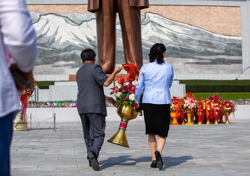 People bringing flowers to the statues of the Leaders in the Grand monument, DGC, Pyongyang, North Korea