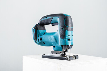 Isolated photo of a cordless jigsaw machine, on white background.