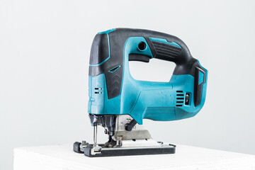 Isolated photo of a cordless jigsaw machine, on white background.
