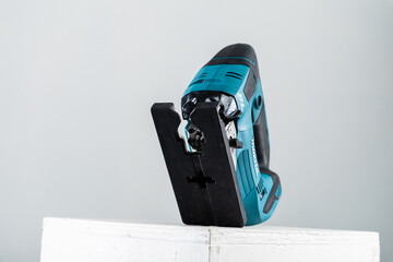Isolated photo of a cordless jigsaw machine, on white background.