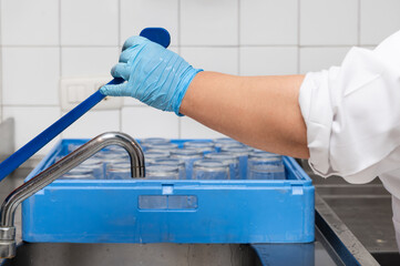 Female hands in latex gloves close up wash in a commercial kitchen. High quality photo