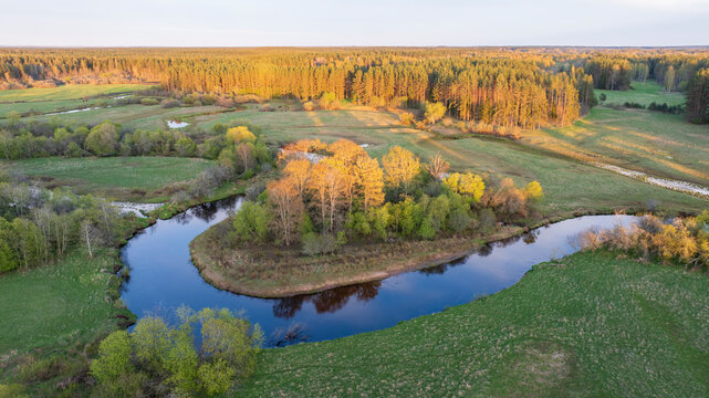 Aerial view to the sunset colored spring landscape of the Mustj&otilde;gi river valley, oxbows and meadows and public watchtower in Tellingum&auml;e, Tsirgum&auml;e k&uuml;la, Valga vald, Valgamaa