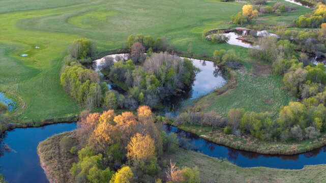Aerial view to the sunset colored spring landscape of the Mustj&otilde;gi river valley, oxbows and meadows and public watchtower in Tellingum&auml;e, Tsirgum&auml;e k&uuml;la, Valga vald, Valgamaa