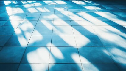 Fototapeta premium Sunlight casts patterned shadows on cool blue tiles