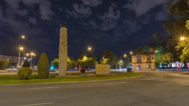 Night Hyperlapse of Juan Sebasti&aacute;n de Elcano Monument in Seville with City Traffic