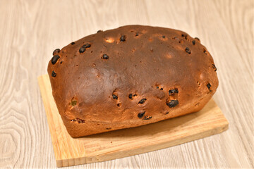 Homemade raisin bread on a wooden stand