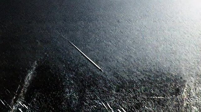 Scratched black metallic surface with deep parallel grooves