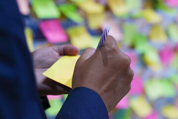 Mockup sticky Note Paper. Hand written notes black pencil on yellow sticker. white table...
