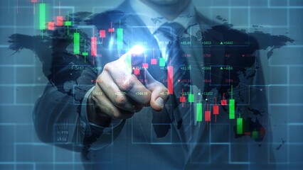 Businessman pointing at glowing financial graph on world map background, representing data analysis