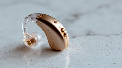 Hearing aid on marble surface showcasing advanced technology and design in a neutral environment