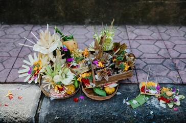 Balinese offerings, called Canang Sari, are left on the ground as a daily offering to the gods and...
