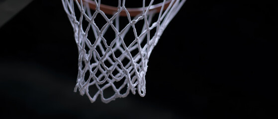 Basketball net with ball falling through in slow motion